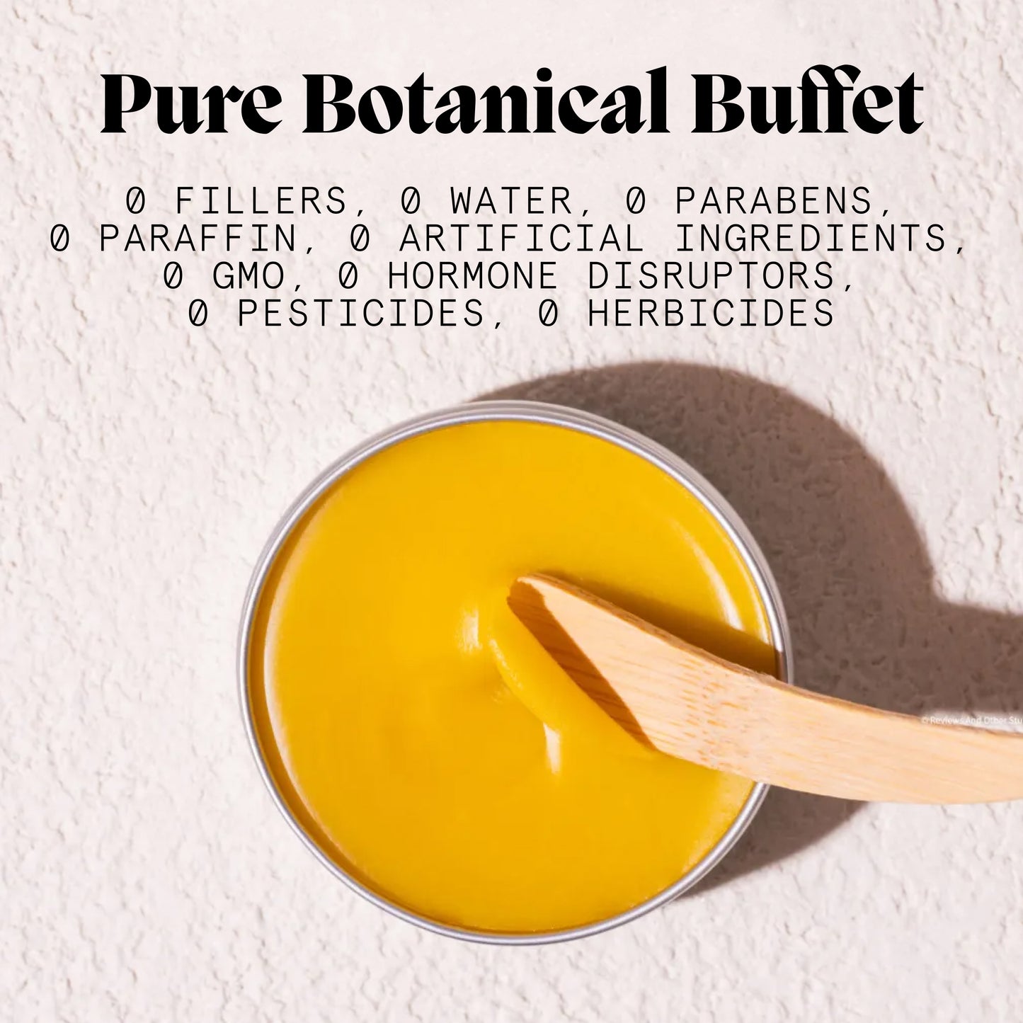 Open Pimple Scars Balm 2.0 tin with bamboo spatula beside a free-from natural ingredients graphic