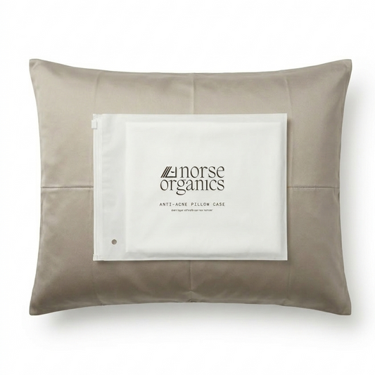 Norse Organics anti-acne bamboo pillowcase in natural beige with a branded product card resting on top